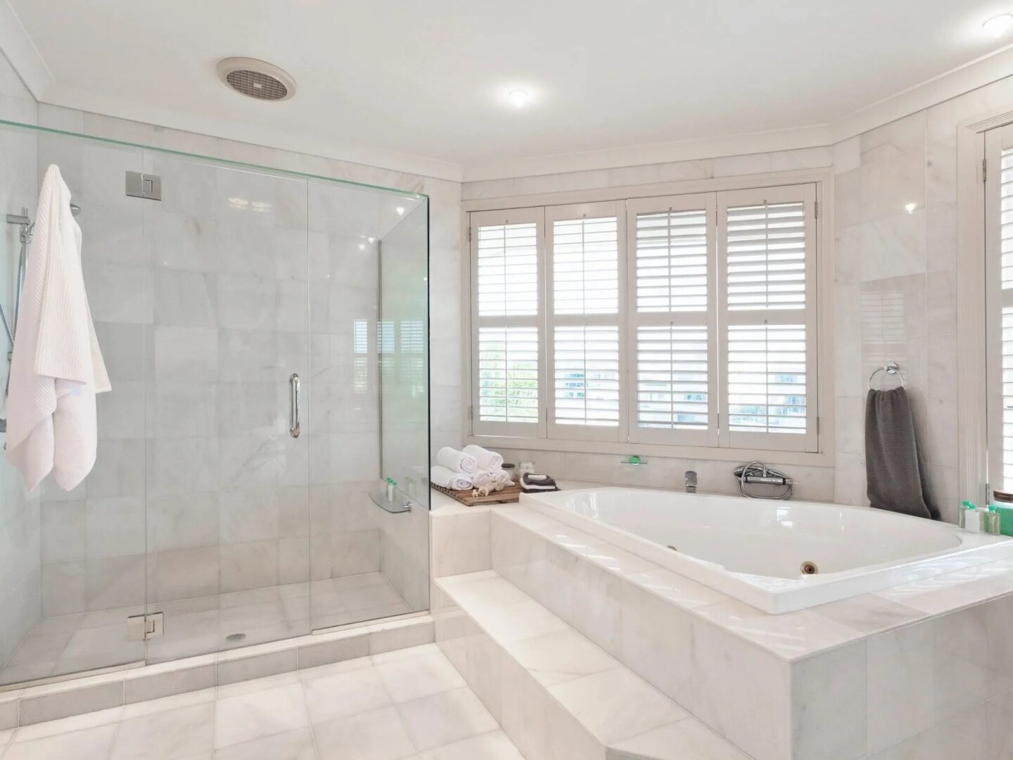 A large bathroom with a tub and shower.