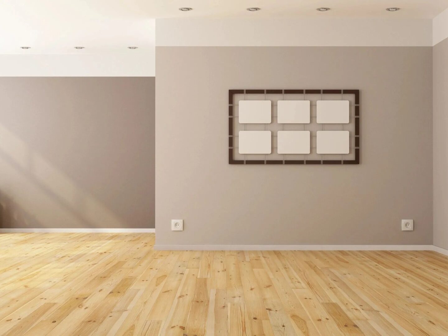 A room with wood floors and a picture frame on the wall.