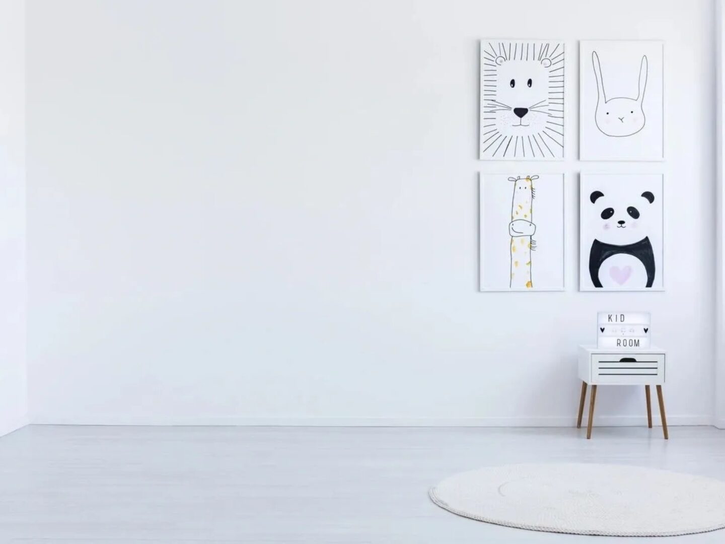 A white room with four black and white pictures on the wall.