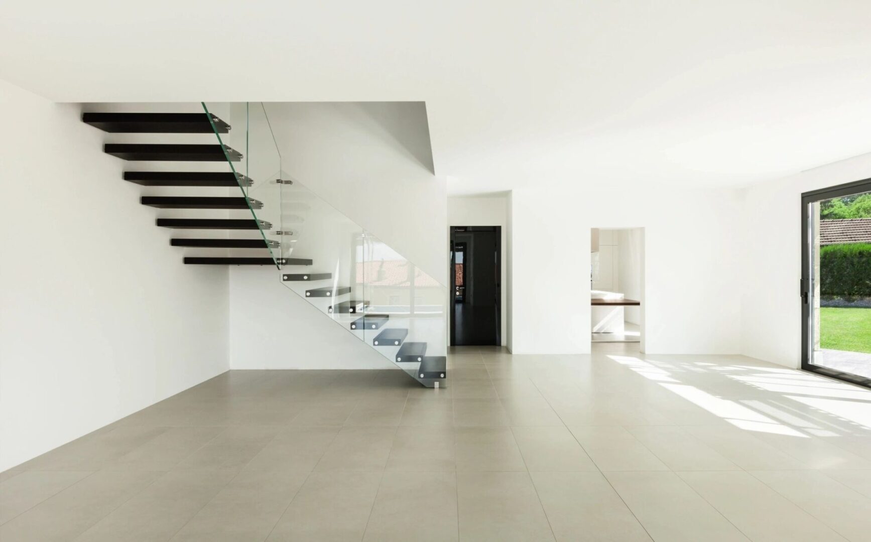 A large room with stairs and a door.